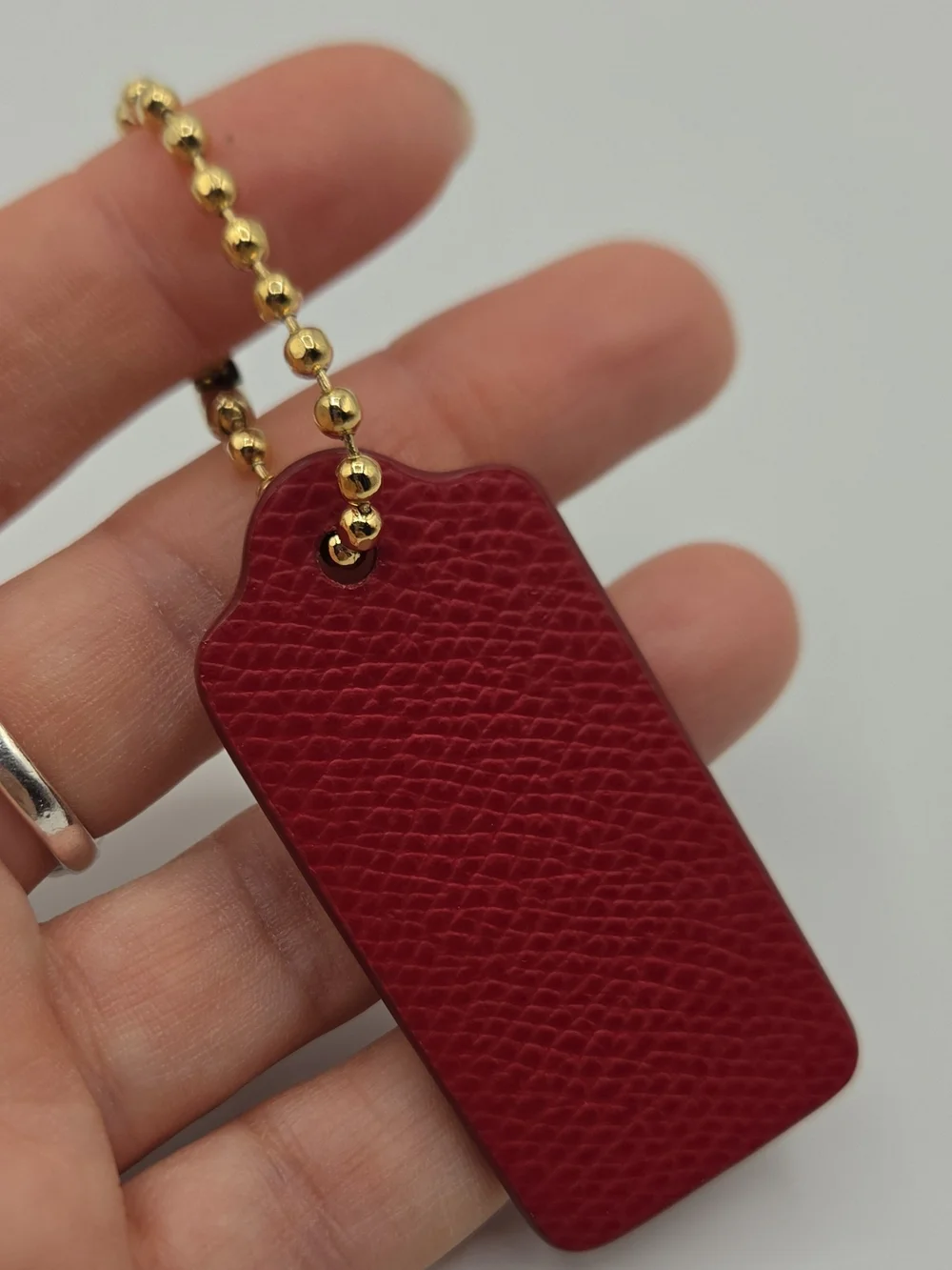 Coach Pink-Red Textured Leather Key Tag with Gold Ball Chain